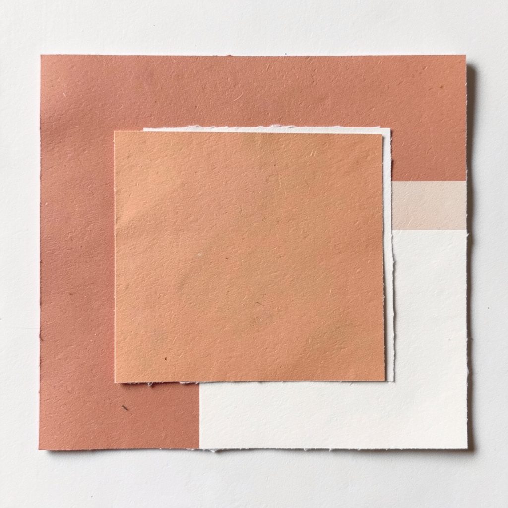 Square layered paper in muted terracotta and off-white.
