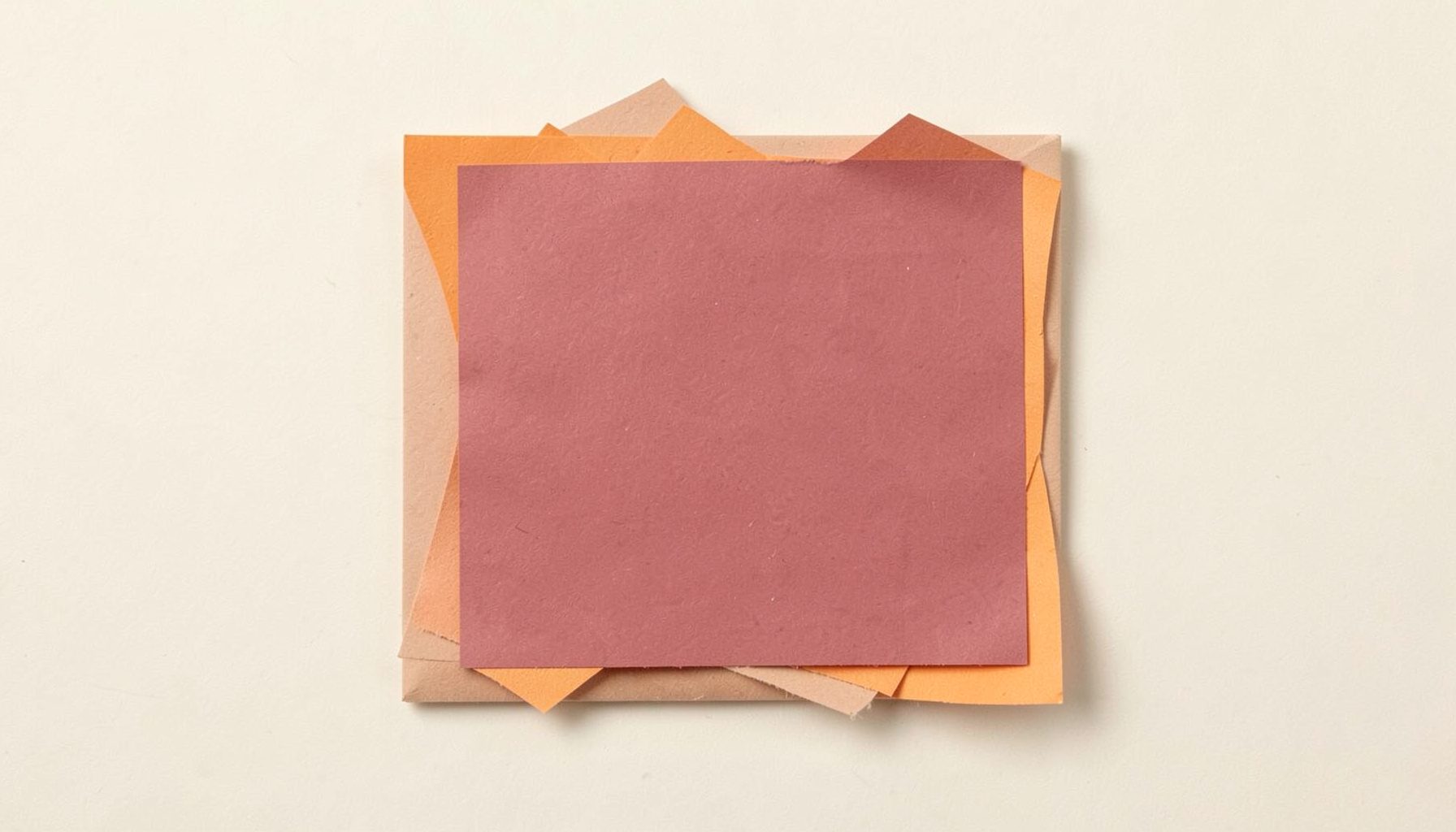 Square paper block in muted red against cream, calm and graphic.