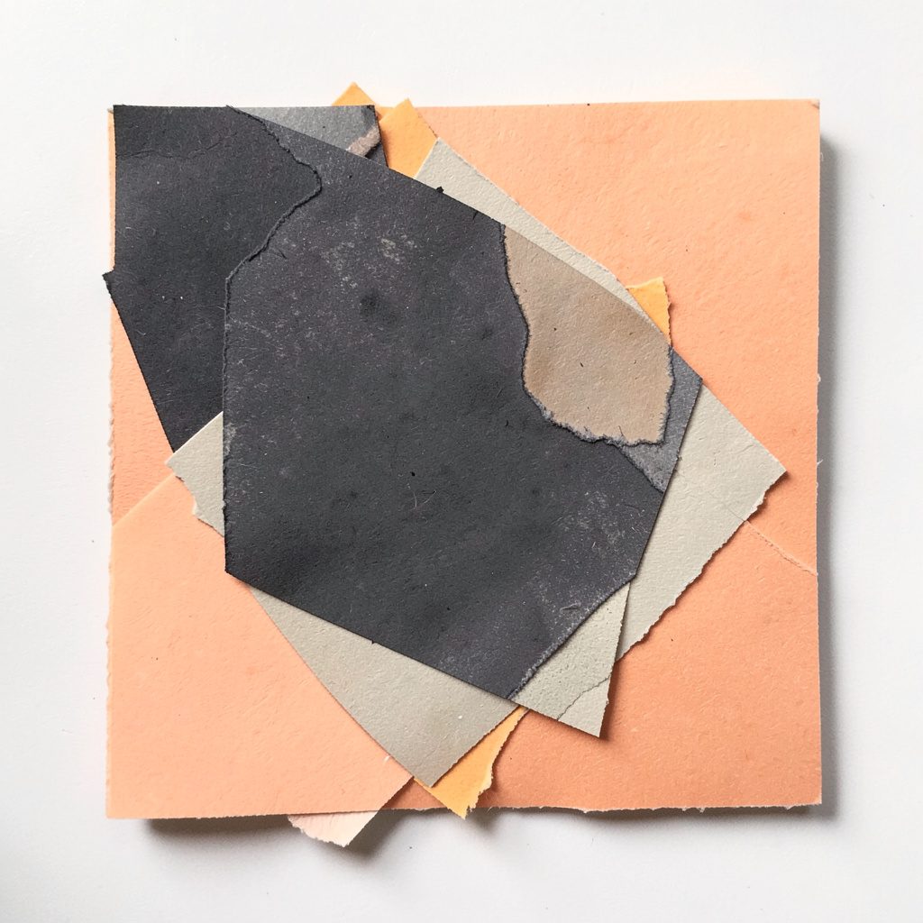 Square paper cut-out with charcoal and peach tonal balance.